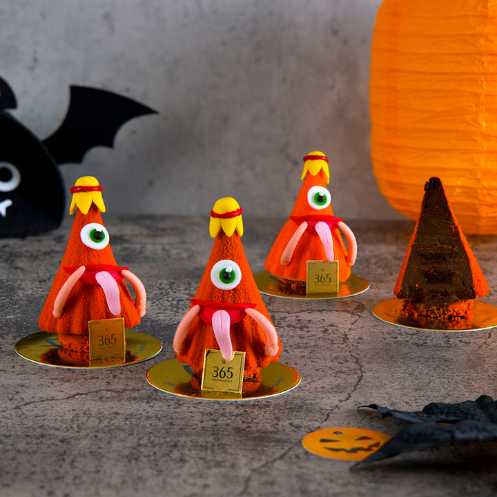 Halloween-themed decorations with orange and brown figures on a textured surface.