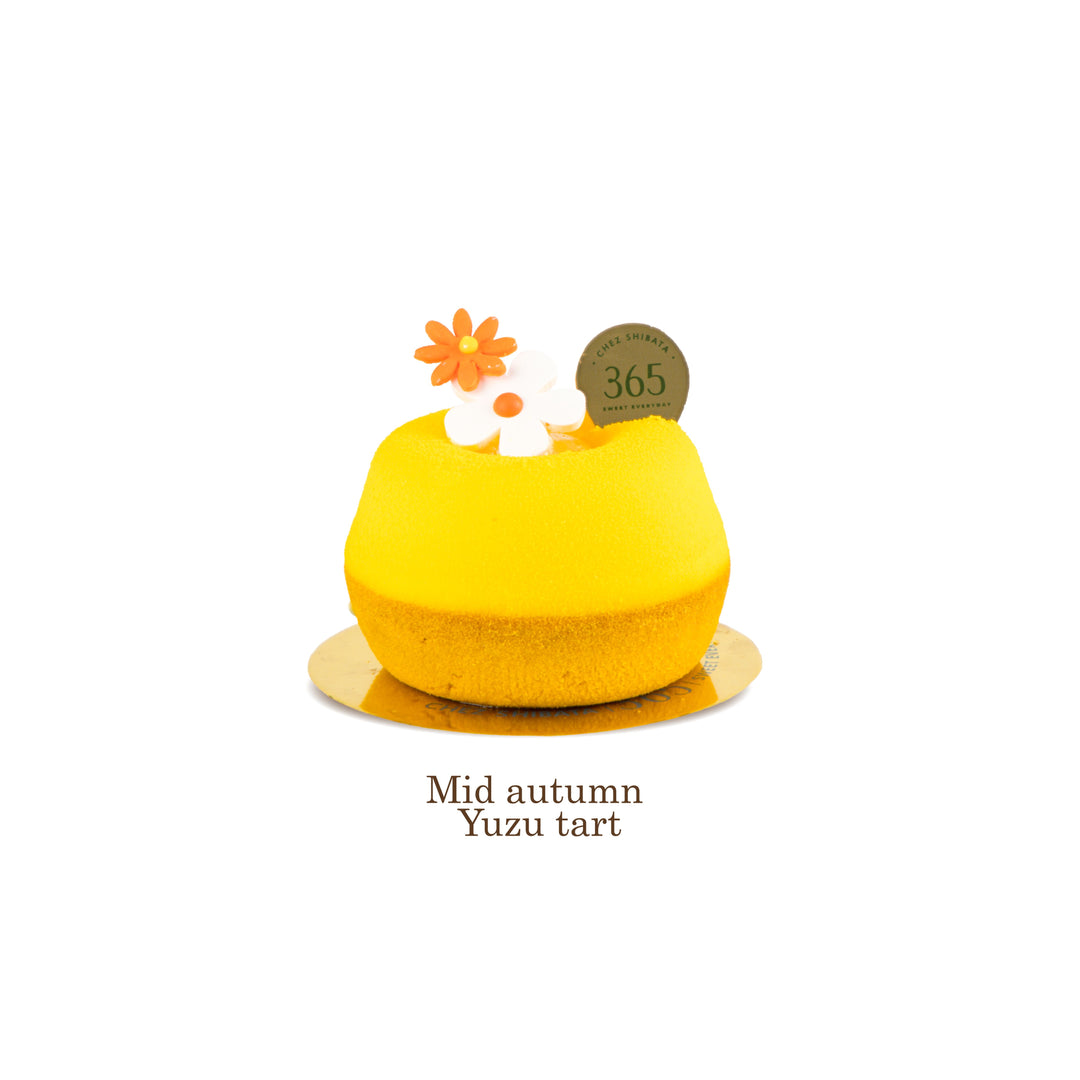 Yellow yuzu tart with decorative elements on a white background