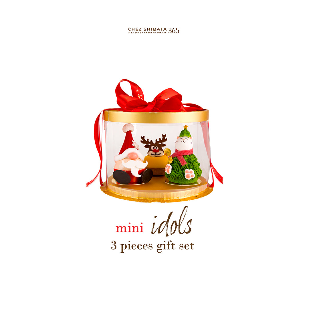 Mini Idols Christmas cake gift set by Chez Shibata 365, featuring three handcrafted mini cakes—Santa, reindeer, and Christmas tree cat—presented in a clear round gift box with a red ribbon.