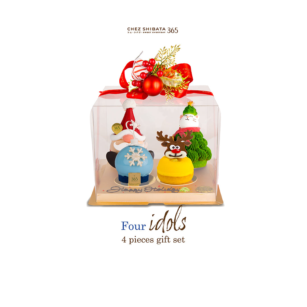 Four Christmas-themed figurines in a clear display box with decorative elements from Chez shibata365