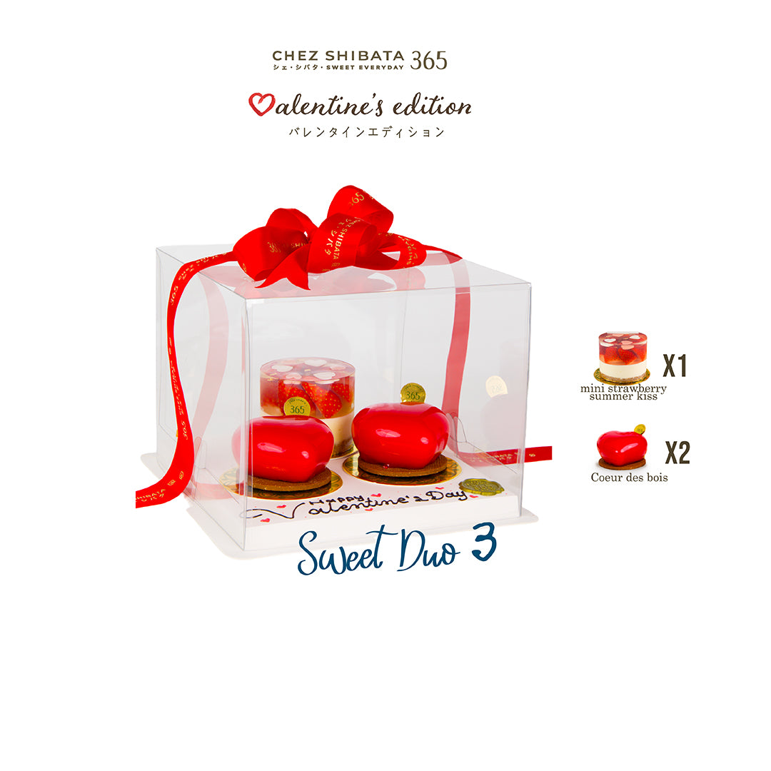 Valentine's edition dessert set in a clear box with a red bow, featuring mini strawberry summer and Coeur des bois desserts.