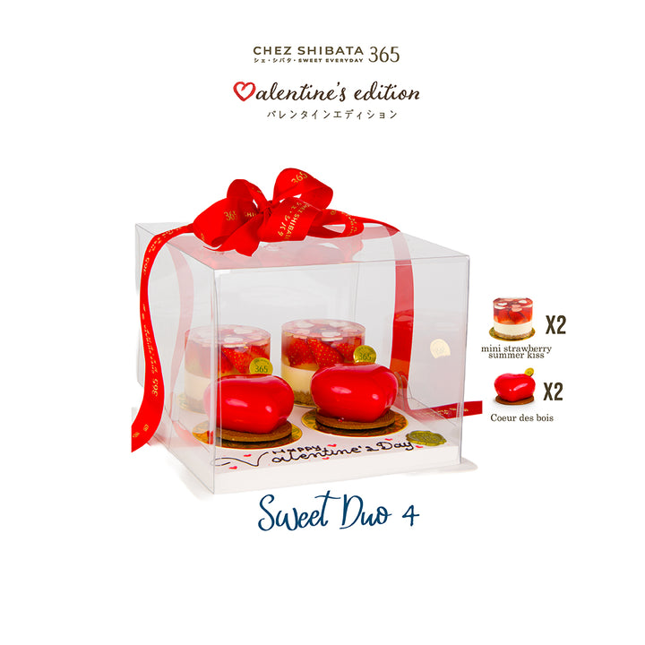 Valentine's edition dessert set in a clear box with a red ribbon, featuring mini strawberry mousse cakes and heart-shaped treats.
