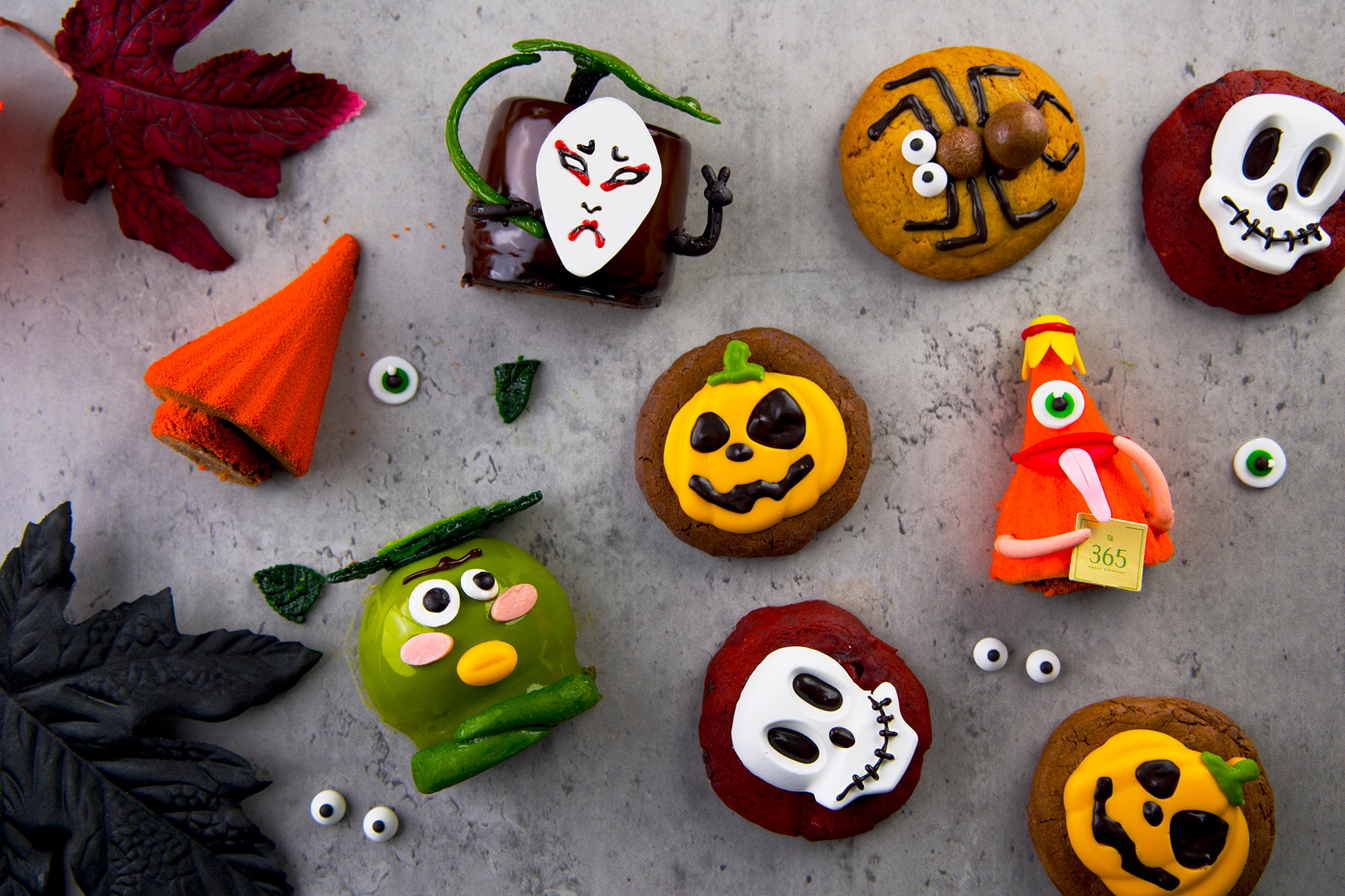 Halloween-themed cookies decorated with icing on a gray surface. Chez Shibata 365 bangkok.