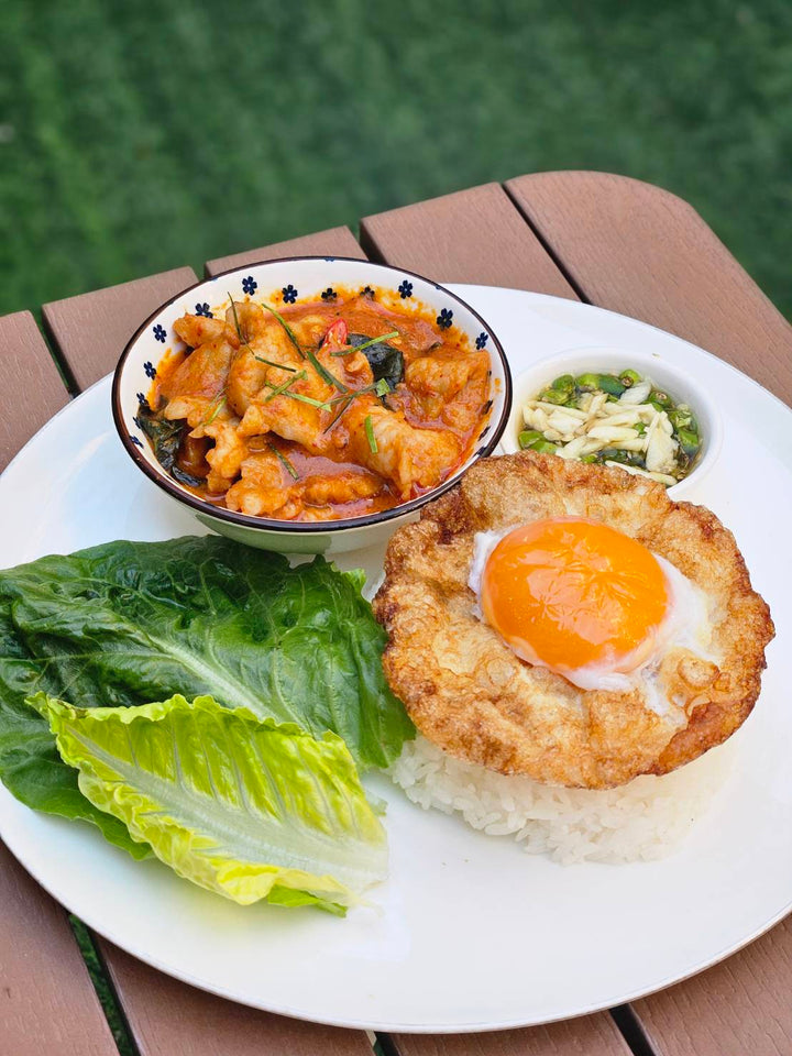 Thai panaeng curry with pork served with steamed jasmine rice, crispy fried egg, fresh greens, and chili fish sauce Chez shibata365