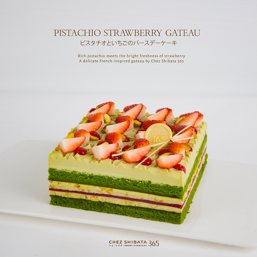 Pistachio strawberry gateau with strawberries on top on a white background