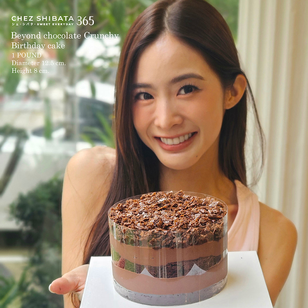 WJmild holding a chocolate birthday cake with 'Chez Shibata' branding.
