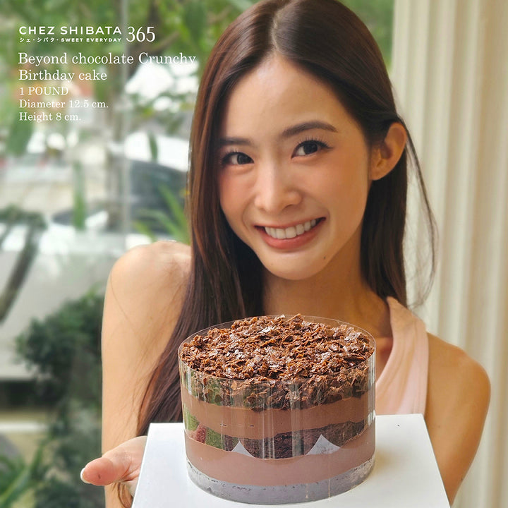 WJmild holding a chocolate birthday cake with 'Chez Shibata' branding.